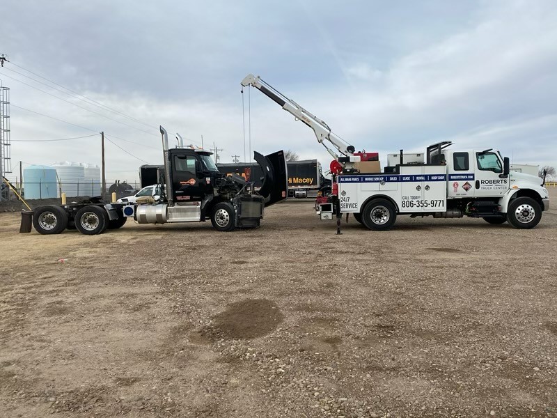 Our mobile service truck outside with the crane deployed while working on a customer's vehicle.